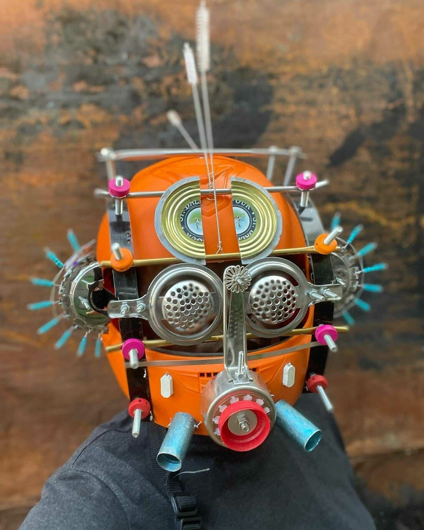 an elaborate mask made from found objects
